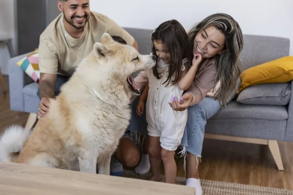 hispanic family on the couch with their dog yawning