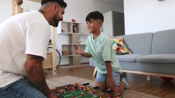 西班牙裔父亲和他的儿子在家里打脚球 — 图库视频影像