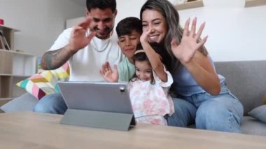 Mutlu Latin Amerikalı aile dijital tabletle evde - video çağrısı ve aile hayatı konsepti -