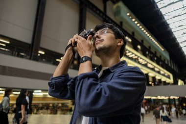 Turist şehirde bir kamerayla fotoğraf çekiyor. Gezgin gezgini konsepti. -