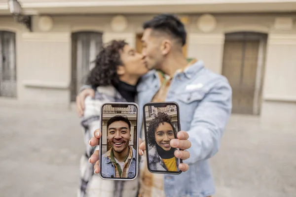 Multicultural couple meets through a dating app, they meet and fall in love, the focus is on the cell phone that shows their portrait