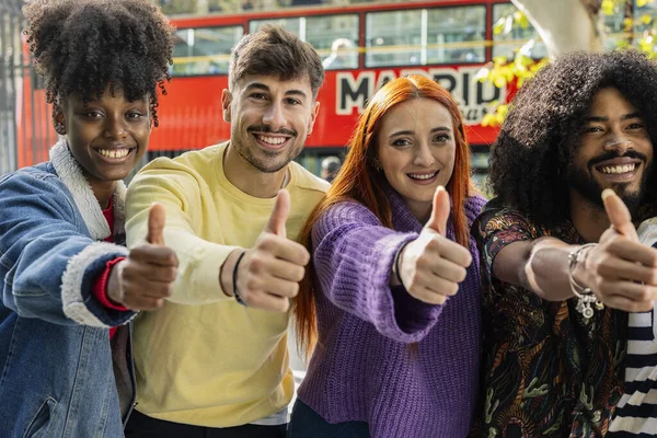 Portrait of a team of multiracial coworker friends confidently giving to young and mature colleagues looking at camera with smiling face with thumbs up giving ok