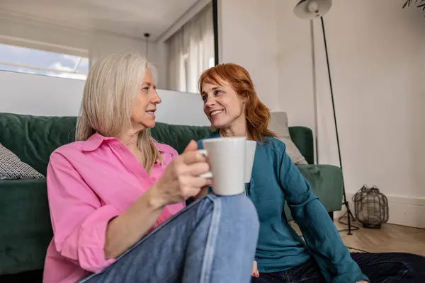 Two Women Sharing a Relaxing Coffee Break in a Modern Home