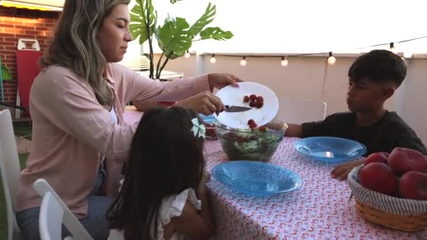 Family Shares Wholesome Meal Outdoors Well Lit Terrace — Stock Video