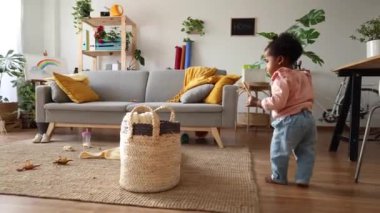 Gururlu bir anne izlerken bir bebek ilk adımlarını atar..