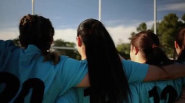 Mavi formalı kadın rugby oyuncuları bir araya toplandı, maç öncesi birlik ve takım ruhunu sergilediler..