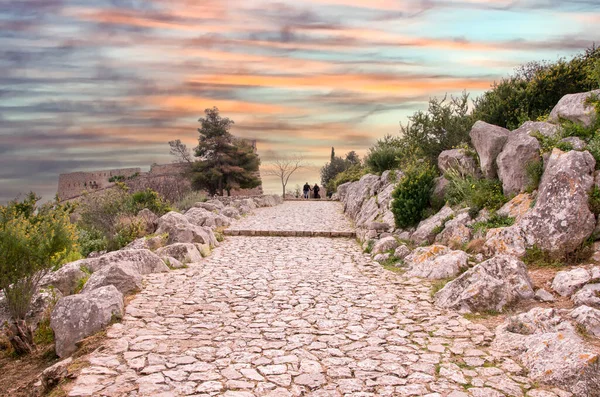 Couple walking on stone path at sunset .Greece