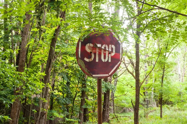 Creepy stop road sign in the middle of an abandoned area