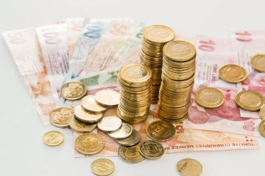 Turkish money,banknotes on the white surface with stacked coins