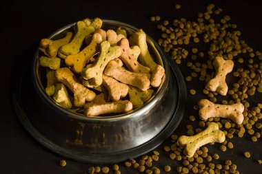 Pet animal biscuits with salmon, bone-shaped, in metal food bowl