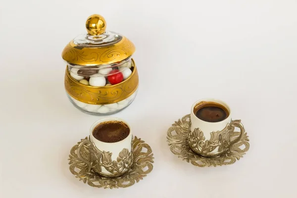 Traditional Turkish Hard Almond Candies designed in stylish candy bowl with coffee