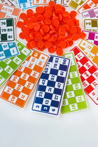 Colorful bingo game cards and numbers on white background with copy space
