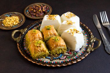 Geleneksel Türk Marası, yuvarlak bakır tabakta baklava ile tasarlanmış dondurmayı kesti