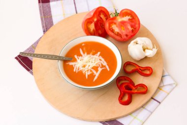 Traditional Turkish cheese tomato soup with tomatoes and garlic on a wooden board clipart