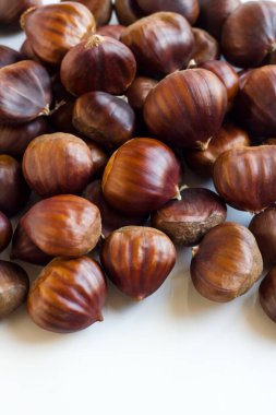 New harvest, ripe shelled chestnuts, designed on a white surface with copy space