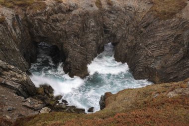 Sea caves and arches at Dungeon Provincial Park near Bonavista, Newfoundland, Canada clipart