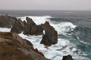 A rocky shoreline on the Atlantic Ocean  in The Dungeon Provincial Park, Bonavista Peninsula Newfoundland and Labrador, Canada. clipart