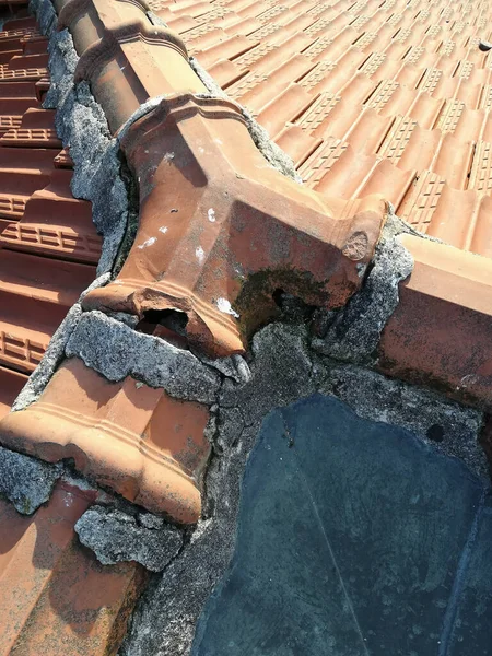 damaged roof tiles after storm in need of waterproofing