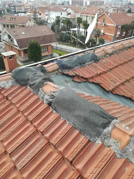 damaged roof tiles emergency patched after storm