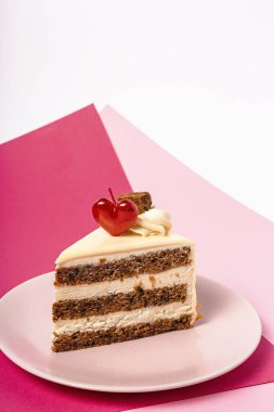 Background of carrot cake with heart candle for Valentine's Day on magenta and pink background