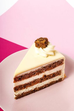 Background of carrot cake with heart candle for Valentine's Day on magenta and pink background