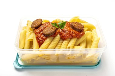 Macaroni with tomato sauce, chorizo and cheese in plastic container ready to eat to take away with white background. Isolated