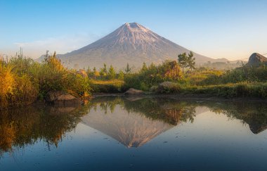 Semeru mountain andreflection in the morning clipart