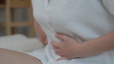 woman Menstrual aches , hand hold on stomach from ache, suffer from food poisoning, abdominal pain, colon problem, gastritis, diarrhea, Patient belly, abdomen, inflammation, cramps, intestines cancer.