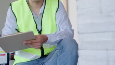 inspector or engineer is inspecting construction house using a checklist. Engineers and architects or contactor count materials for construction. Building, check, insurance house, quality, foreman.