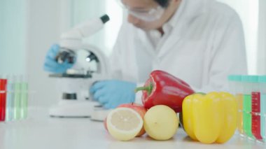 Scientist check chemical food residues in laboratory. Control experts inspect quality of fruits, vegetables. lab, hazards, ROHs, find prohibited substances, contaminate, Microscope, Microbiologist