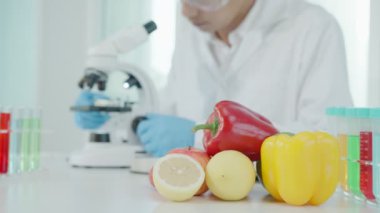Scientist check chemical food residues in laboratory. Control experts inspect quality of fruits, vegetables. lab, hazards, ROHs, find prohibited substances, contaminate, Microscope, Microbiologist