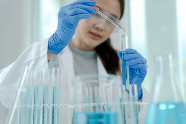 Scientist analyze biochemical samples in advanced scientific laboratory. Medical professional use dropper mix microbiological developmental of viral. Biotechnology research in  science lab. cosmetic