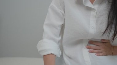 stomach ache. Asian women have abdominal pain, indigestion, gastritis, menstrual cramps, flatulence, diarrhea, distention, colon cancer, belly inflammation problem, suffer food poisoning, abdomen