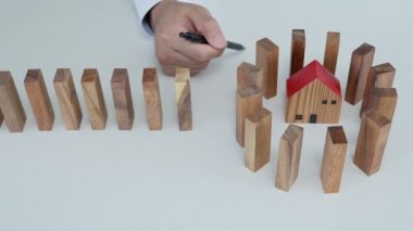 insurance with protect domino. Businessman stop dominoes falling in business crisis. business risk control and planning and strategies to run prevent insurance businesses.