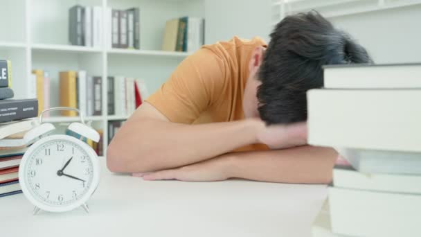 Asian Student Man Turns Alarm Clock Because Tired Reading Male — Vídeos de Stock