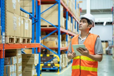 asian man business owner using checklist recheck amount of stock product inventory on shelf at distribution warehouse factory.logistic business ship and delivery, inventory flow, professional.