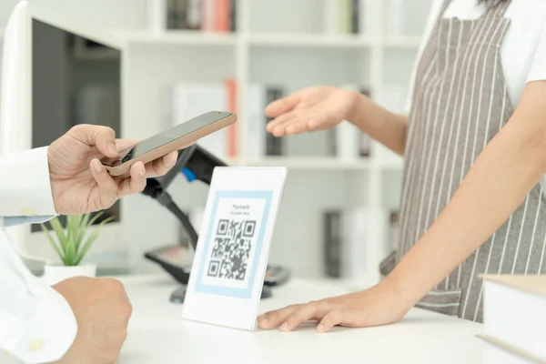 Customer use smartphones to scan QR codes to pay in-store with digital payments without cash. scanning get discounts. E wallet, technology, online payment, banking app, smart city, money transfer