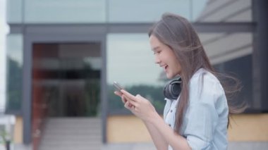Asian beautiful woman exited surprise face expression . female feels shocked with the phone. exciting smile and happy adorable rejoices. Very enjoy and fun relax time. wow, girl holding smartphone.