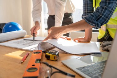 Engineers team discuss check and review the blueprint of construction. Contractor inspection drawing before start project civil. Prepare construction project planning, consulting, architecture.