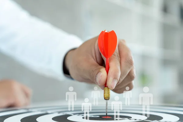 Businessman set goals for work. Hand holding a dart aiming at the target center business. goal, aiming marketing target metaphor, Succeed dart board, defines objectives, success investment ideas.