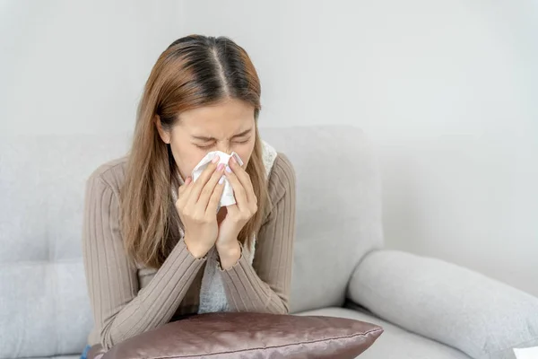 sick woman with a headache and feeling cold on sofa, female sneezing and runny nose with seasonal influenza, allergic, high fever and influenza, resting, virus, coronavirus, feel illness, respiratory