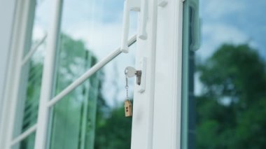 Landlord key for unlocking house is plugged into the door. Second hand house for rent and sale. keychain is blowing in the wind. mortgage for new home, buy, sell, renovate, investment, owner, estate