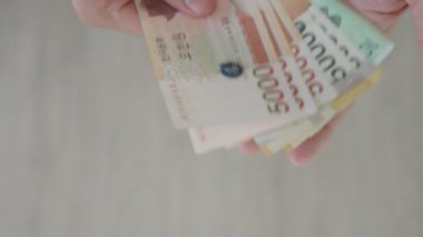 The currency of Korea which is used to represent value in exchange and the won is the main currency of Korean people. Korean won notes for money concept background.