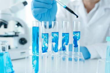 Scientist analyze biochemical samples in advanced scientific laboratory. Medical professional use dropper mix microbiological developmental of viral. Biotechnology research in  science lab. cosmetic