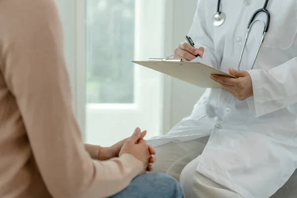 stock image woman with mental health problems is consulting. psychiatrist is recording the patient's condition for treatment. encouragement, love and family problem, bipolar , depression patient, protect suicide