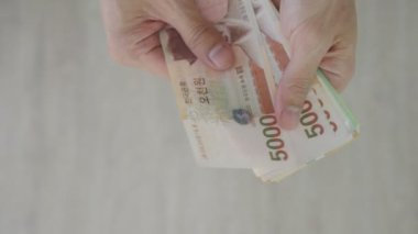 The currency of Korea which is used to represent value in exchange and the won is the main currency of Korean people. Korean won notes for money concept background