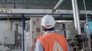 Mechanic or maintenance or electrical engineer checking main electrical control systems industrial plant. Utility fore man daily check power systems in process. Main Distribution Board, Switchboards