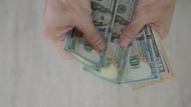 USD currency , Many dollar bank notes Placed on the table.The  Dollar is the currency of USA that is used to change, buy, sell, accumulate, and invest in united kingdom's state people.