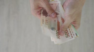 The currency of Korea which is used to represent value in exchange and the won is the main currency of Korean people. Korean won notes for money concept background.