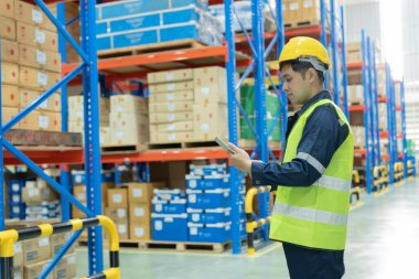 Asian male factory manager inspect goods in warehouse or inventory and check stock product. Transport logistic business shipping, delivery to customers. inspection, storehouse, storage, factory